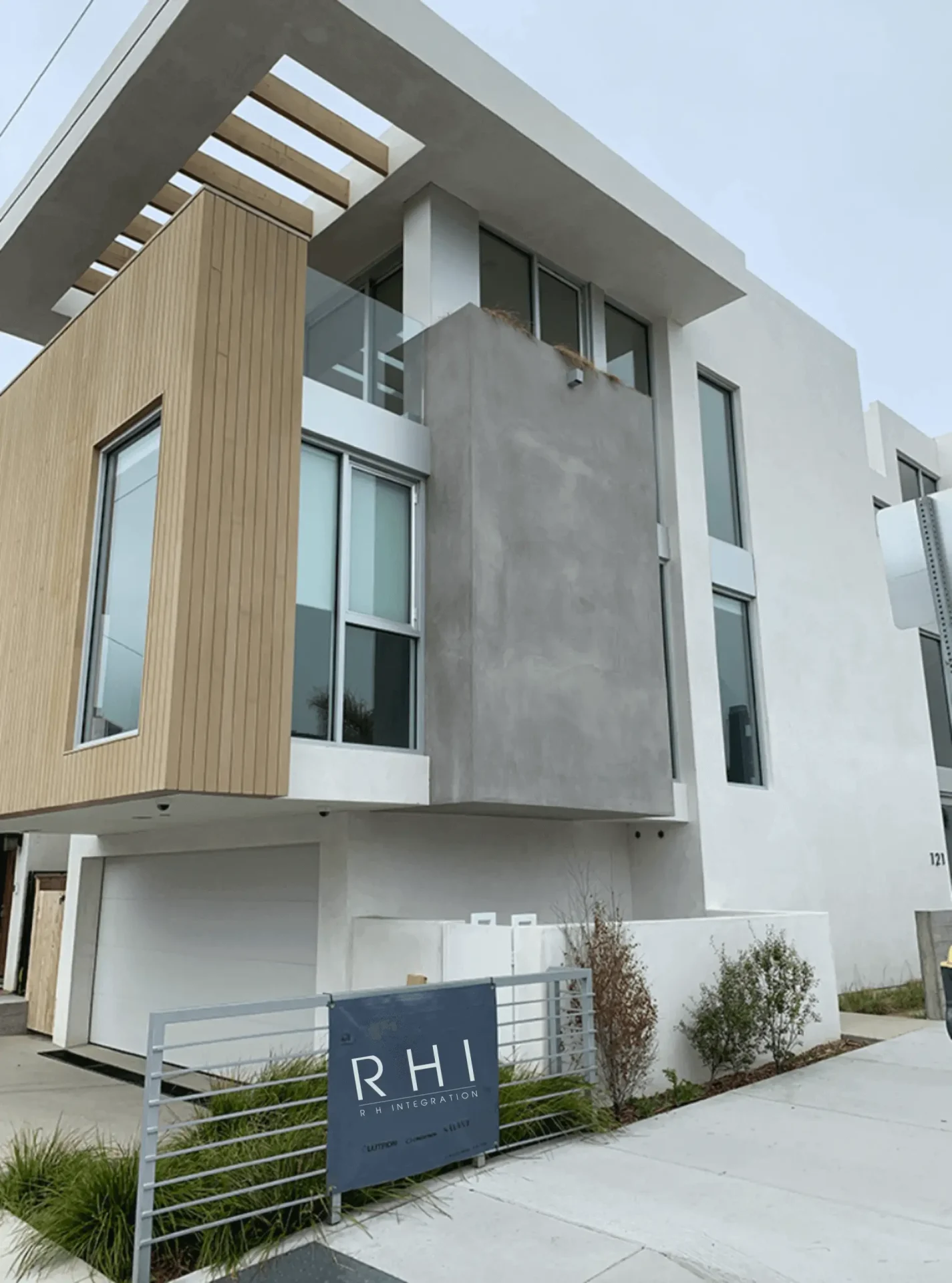 Modern three-story building with large windows.