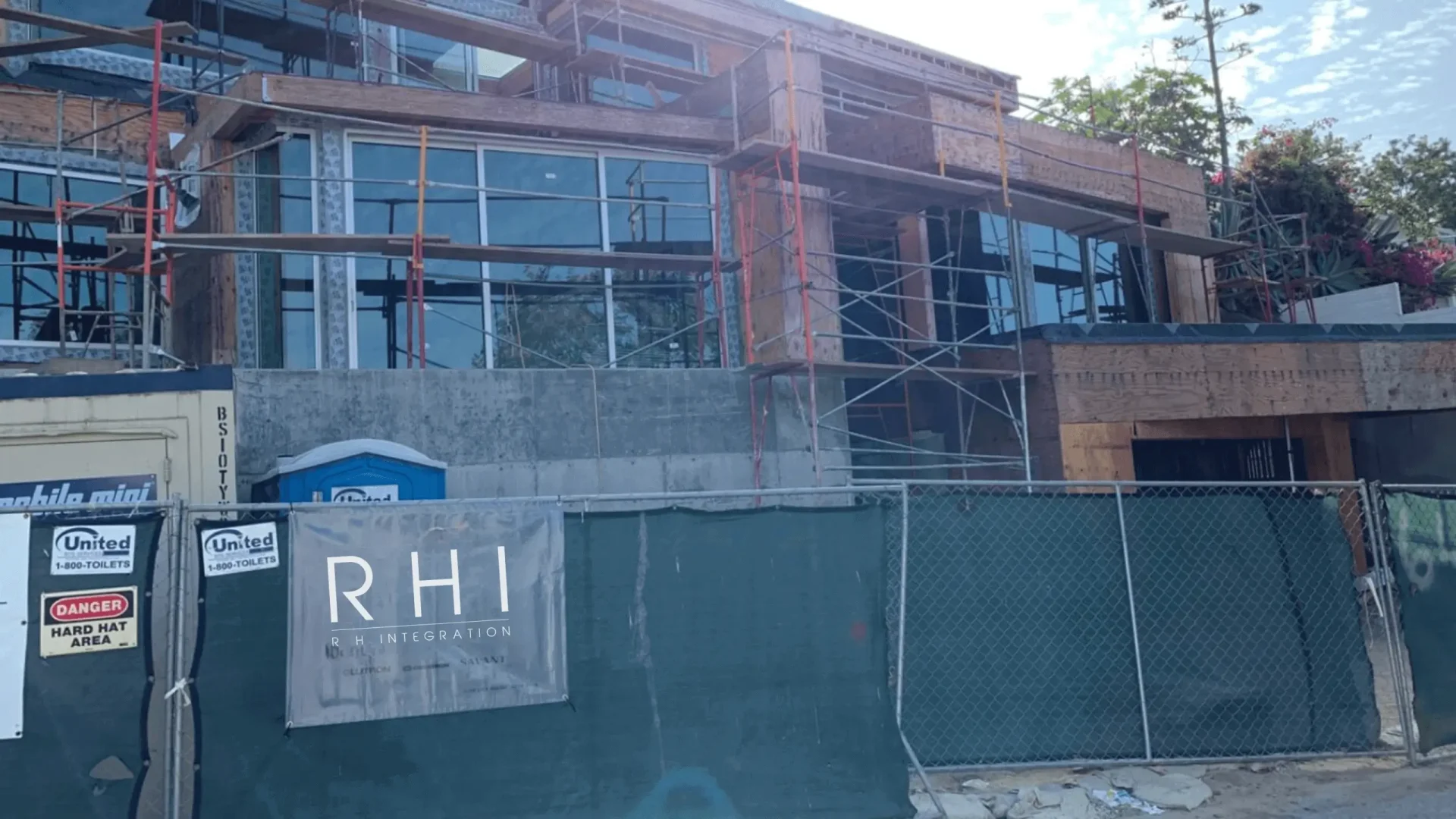 Building under construction with scaffolding and fencing.