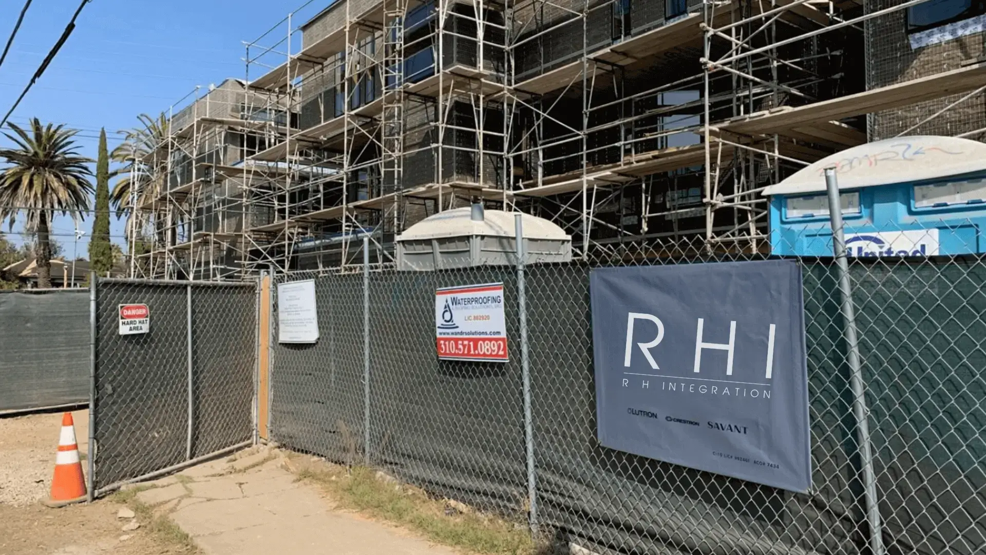 Construction site with scaffolding and fencing.