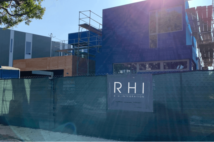 Modern building under construction with scaffolding.