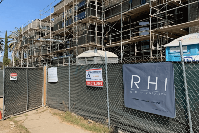 Construction site with scaffolding and fencing.