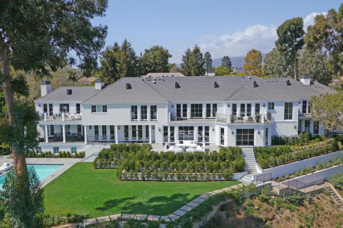 A white mansion with gray roofing