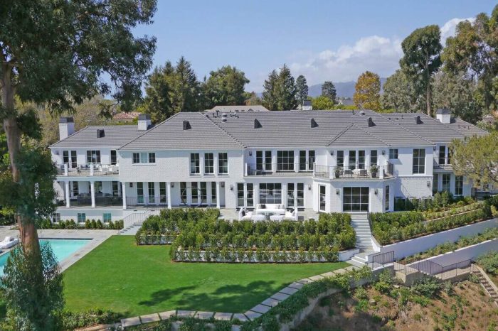 A white mansion with gray roofing